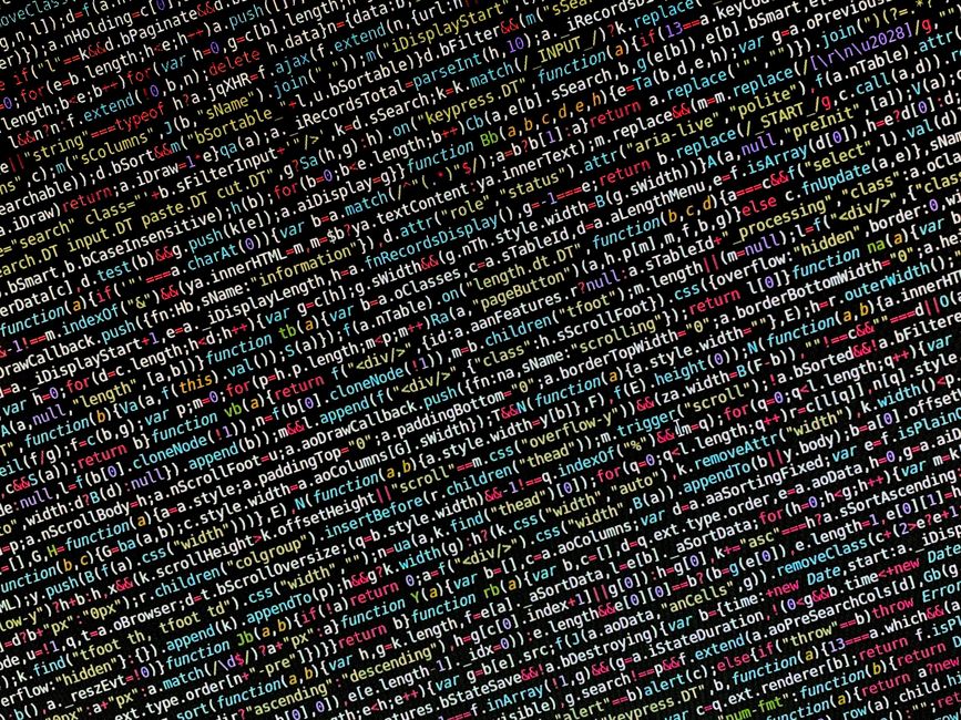 A photograph displaying a dense overlay of computer code and programming language syntax in vibrant colors, including red, yellow, green, blue, and white, on a dark background. The code contains vario